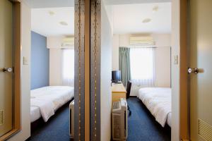 Postel nebo postele na pokoji v ubytování Super Hotel Matsuyama + 29 fotografií