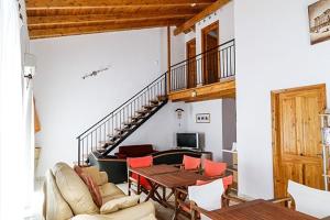 a living room with a couch and a table and a staircase at Seaview Apartments Tsilivi in Tsilivi