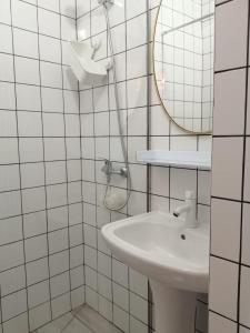 a white bathroom with a sink and a mirror at Dream Days Guesthouse in Faro +33 photos