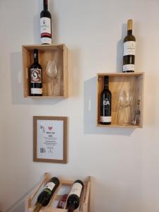 a bunch of wine bottles and glasses on a wall at Dream Days Guesthouse in Faro