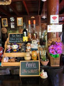a display of bottles of wine and other items in a store at Banthai Guesthouse in Phetchaburi