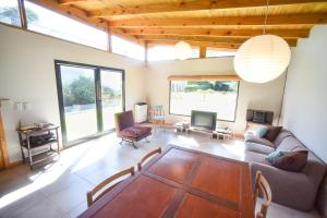 a living room with a couch and a table at Casa Barrio Acantilados proxima al mar in Mar del Plata