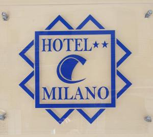 a sign for a hotel milano on a wall at Hotel Milano in Naples