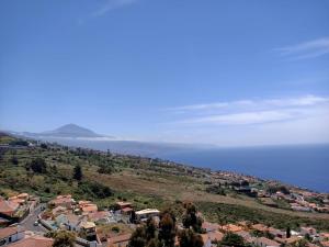 a town on a hill with the ocean in the background at Apartamento Mencey de StarApsTenerife in Sauzal +3 photos
