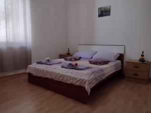a bedroom with a bed with two towels on it at Apartments Eldi in Split