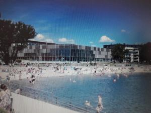 a group of people in the water at a beach at Apartment Bystranda - City Beach in Kristiansand