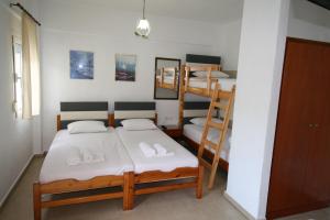 a room with two bunk beds and a staircase at SARTI CENTER studios in Sarti