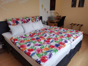 duże łóżko z kolorowym kocem w obiekcie Ferienwohnungen Am Bruttiger Moselsteig w mieście Bruttig-Fankel