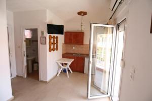 a kitchen with a sliding glass door leading to a bathroom at SARTI CENTER studios in Sarti