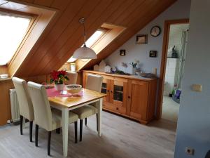 a dining room with a wooden table and chairs at Ferienwohnung 2 - Leopold in Cuxhaven