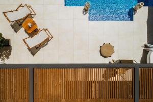 an overhead view of a room with chairs and tables at Emerald Villas & Suites - The Finest Hotels Of The World in Agios Nikolaos