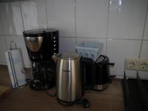 a kitchen counter with two coffee makers on a table at Carl-Schmäcke-Straße 7 in Neuenhagen