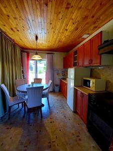 a kitchen with a table and a kitchen with red cabinets at apartman toni in Trogir