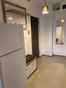 a kitchen with a white refrigerator in a room at VD Apartament in Constanţa