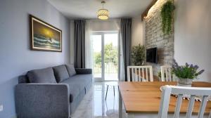 a living room with a couch and a table at Guest House Ambienti in Rovinj