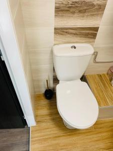 a bathroom with a white toilet in a room at Bitter súkromné ubytovanie in Štúrovo