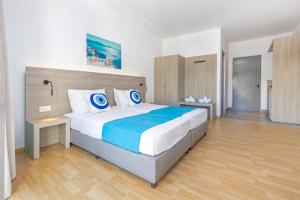 a bedroom with a large bed in a room at Vergina Sun in Faliraki