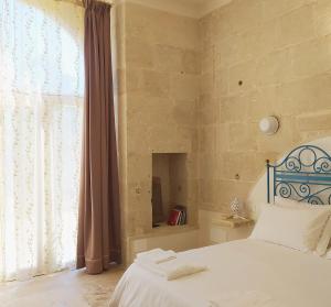 una camera con un letto e una grande finestra di Giardino Frannicola a Maglie