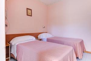 Postel nebo postele na pokoji v ubytování Hotel Sorriso
