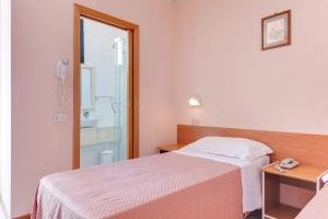 Postel nebo postele na pokoji v ubytování Hotel Sorriso