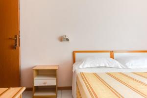 Postel nebo postele na pokoji v ubytování Hotel Sorriso