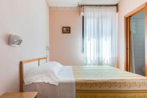 Postel nebo postele na pokoji v ubytování Hotel Sorriso
