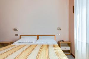 Postel nebo postele na pokoji v ubytování Hotel Sorriso