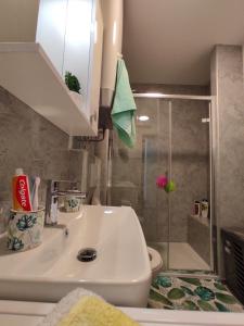uma casa de banho com um lavatório e um chuveiro em Apartment Ravnice em Omiš