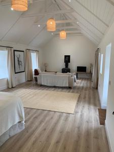 a bedroom with two beds and a living room at The Bothy at Arndean in Dollar