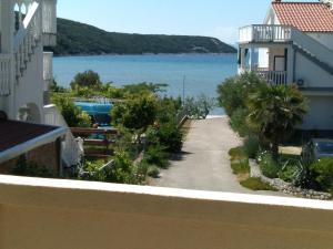 a view of the ocean from a balcony at Apartments Kampor Damira in Rab