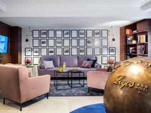 a living room with a couch and a table at Hotel Logos Kraków in Krakow