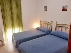 two beds sitting next to each other in a bedroom at EDIFICIO ALGAIDA - NEW VISTA MONTAÑA - PLAYA DE LA CONCHA in Oropesa del Mar +22 photos