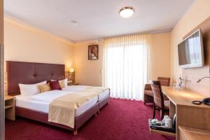 Ένα ή περισσότερα κρεβάτια σε δωμάτιο στο Hotel An der Eiche