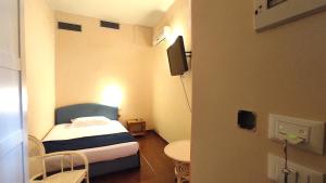 Postel nebo postele na pokoji v ubytování Hotel Rita Major