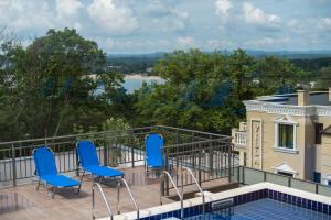 a balcony with blue chairs and a view at Cinema Hotel in Primorsko