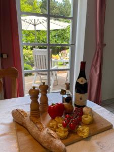 a table with a bottle of wine and food on it at NTAB10002-FeWo-Moeoevwarder-twee in Neue Tiefe Fehmarn