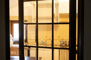 a view of a kitchen through a glass door at LA CASA DI NEH in Rivalba