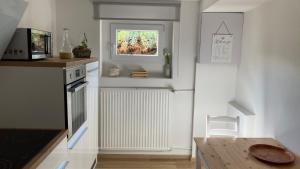 a kitchen with a table and a radiator and a window at Ferienwohung am Edersee in Waldeck Sachsenhausen in Waldeck