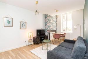 a living room with a couch and a table at ART & DECO - STUDIO COEUR DE VILLE in Agen
