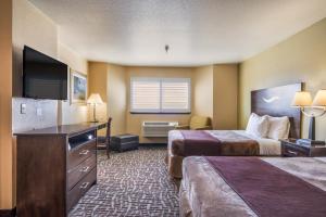 a hotel room with two beds and a flat screen tv at Americas Best Value Inn San Francisco/Pacifica in Pacifica