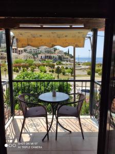 シヴォタにあるSivota Rooms Athanasiouのテーブルと椅子、海の景色を望むバルコニー