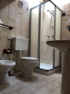 a bathroom with a toilet and a shower and a sink at Appartamenti Il Castello in Saint-Pierre