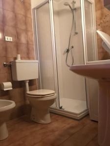 a bathroom with a shower and a toilet and a sink at Appartamenti Il Castello in Saint-Pierre