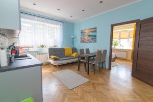 uma cozinha e sala de estar com um sofá e uma mesa em Apartament z jacuzzi em Hel