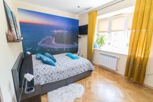 a bedroom with a bed and a flat screen tv at Apartament z jacuzzi in Hel