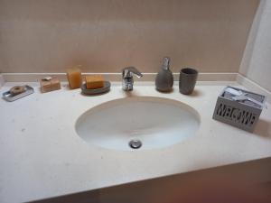 a bathroom sink with a white counter top at PETRA casa vacanza e non solo in Guspini