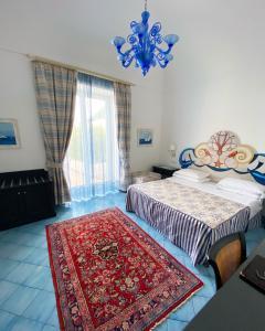 a bedroom with two beds and a red rug on the floor at Palazzo Marzoli charme Resort - Small Luxury Hotel in Positano