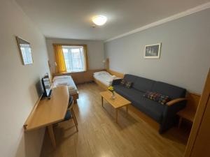 a living room with a couch and a table at Hotel Laguna & restaurant in České Budějovice