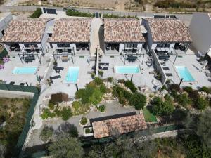 an aerial view of a resort with several pools at Le Domaine De Marie in Palasca