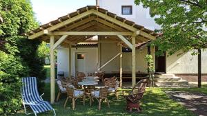 a patio with a table and chairs under awning at Kuca na selu sa bazenom in Štitar